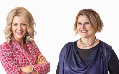 Two women with their arms crossed in front of a white background